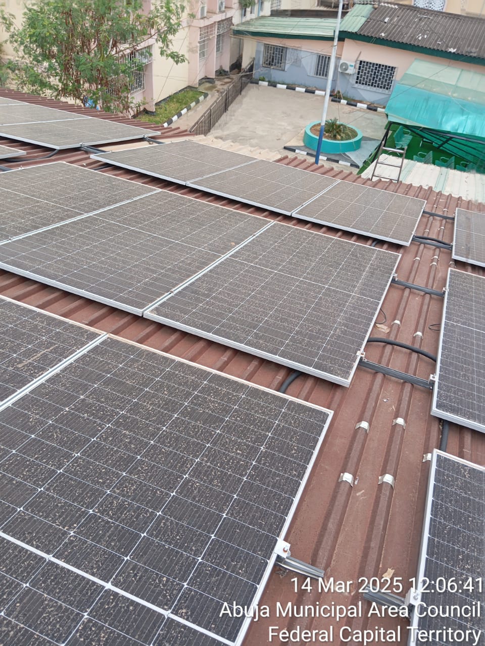 Multi-panel commercial solar PV array installed across a corrugated rooftop
