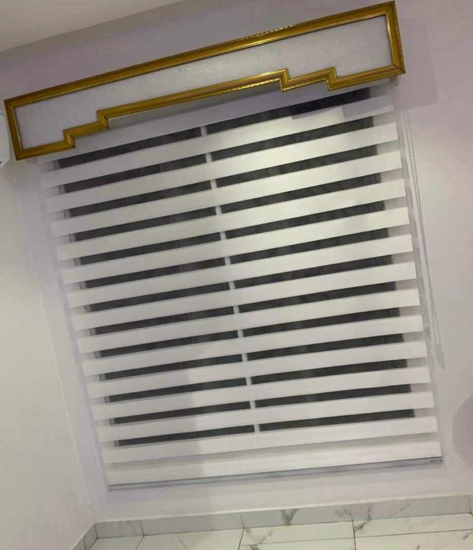 Neutral day-and-night zebra blind fitted within a window recess