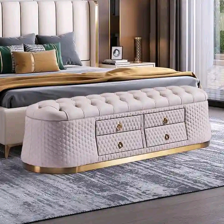 Light grey diamond-tufted bedroom bench with drawers and gold feet