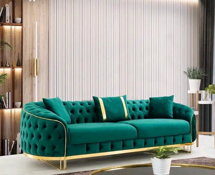 Emerald green channel-tufted sofa in a bright living room