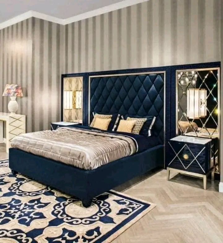 Navy upholstered bedroom suite with mirrored panels and gold accents