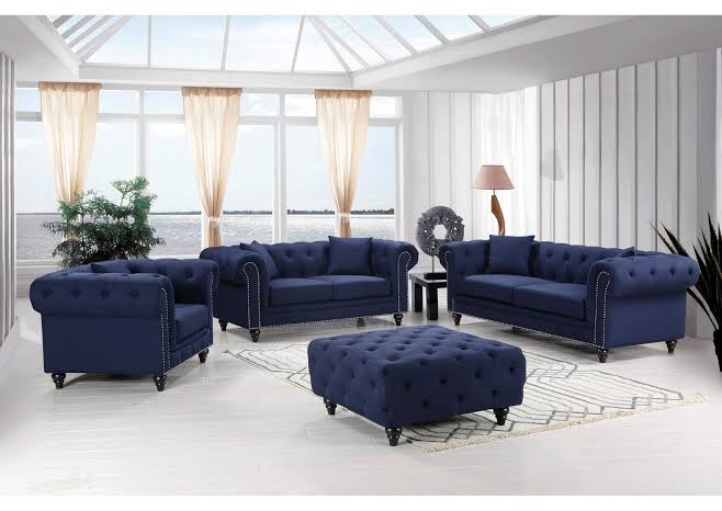 Midnight blue Chesterfield sofas, armchairs and matching tufted ottoman
