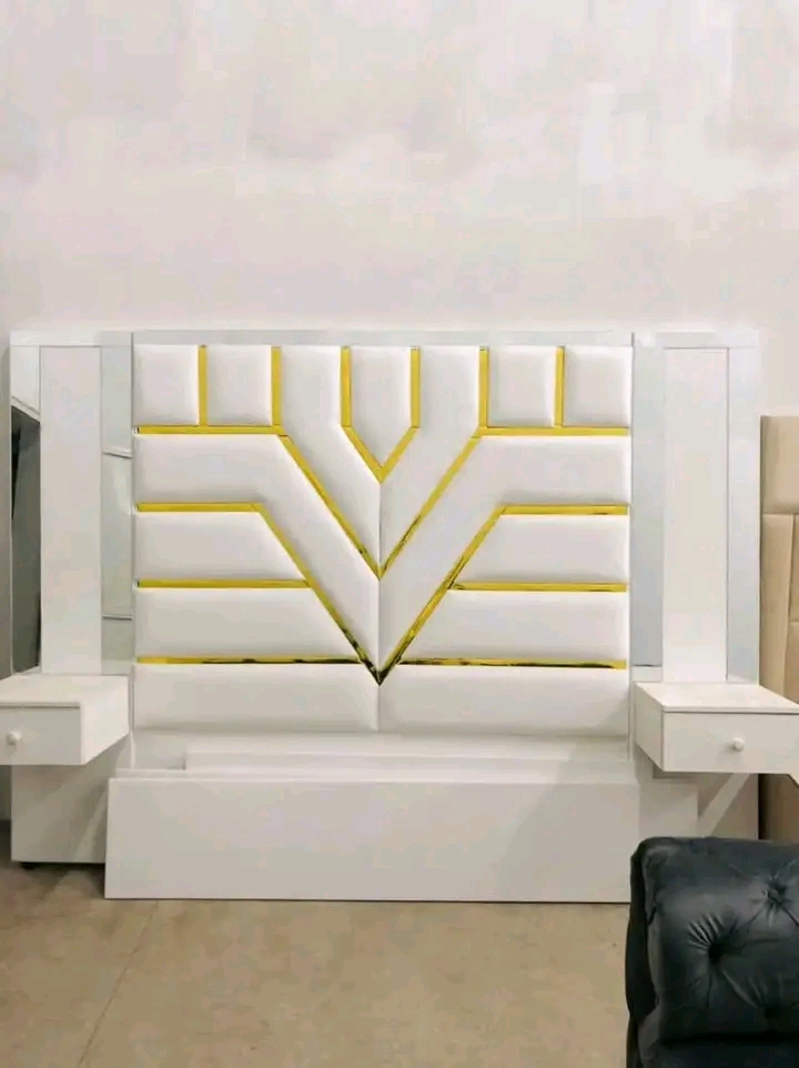 Royal blue bed with tall button-tufted headboard and matching side units
