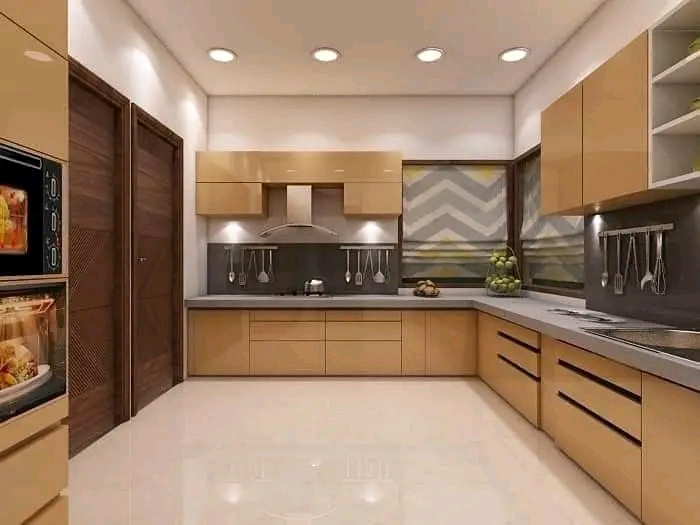 Contemporary warm wood fitted kitchen with pale worktops